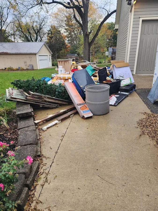 Dumpster being loaded with debris for Estate Cleanout Dumpster Rental in Forest